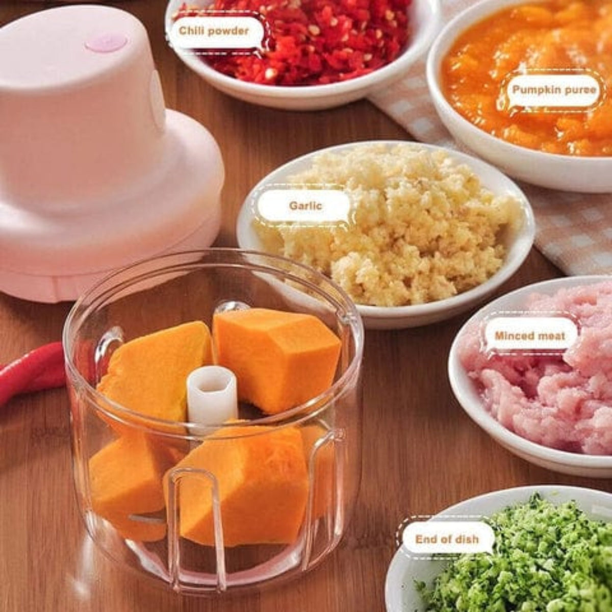 Mini electric garlic chopper chopping vegetables and garlic